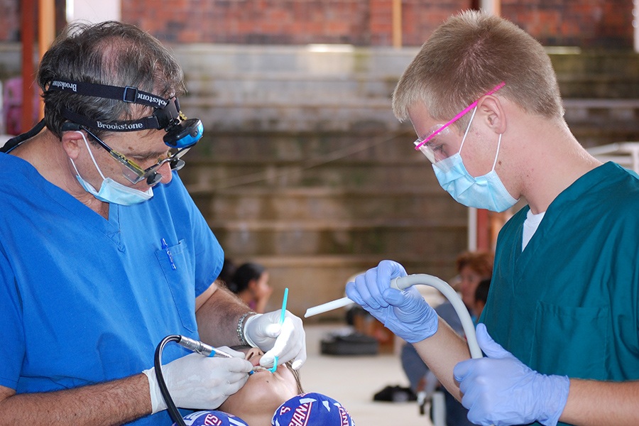 Dentist and team member providing dental treatment