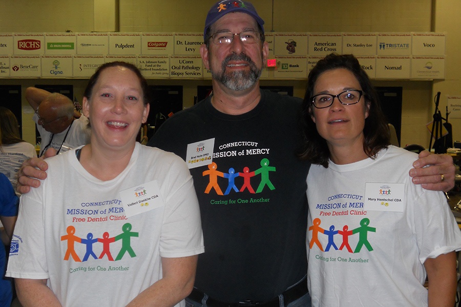Three team members wearing Connecticut Mission of Mercy shirts